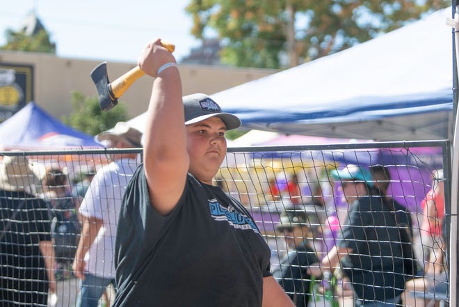 Javan Thompson sets his sights on the target in an axe throwing booth at the 28th Annual Chile and Frijoles Festival on Saturday, Sept. 24, 2022.