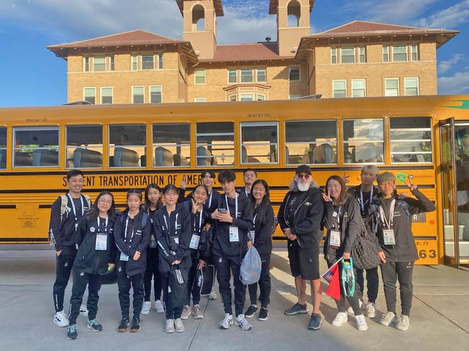 Student Transportation of America school bus driver Anthony Gervais of Pueblo poses for a picture with Team Taiwan during the International Jump Rope Union World Championships.