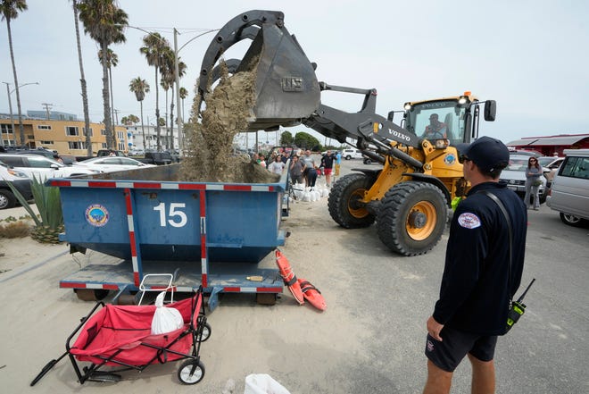Residents wait in line to fill up their sandbags ahead of Hurricane Hilary, in Long Beach, Calif., Saturday, Aug. 19, 2023.