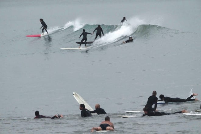 Surfers ride waves at Doheny State Park Beach in Dana Point, Calif., Sunday, Aug. 20, 2023.