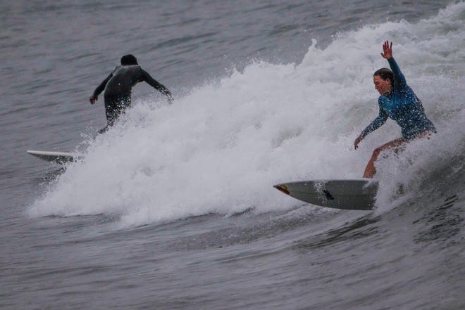 Surfers ride waves off Doheny State Park Beach in Dana Point, Calif., Sunday, Aug. 20, 2023.