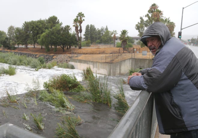 Simi Valley resident Juan Rolar watches as the water rises in the Arroyo Simi Greenway near Rancho Simi Community Park off Erringer Road in Simi Valley on Sunday, Aug. 20, 2023.