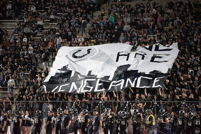 The Pueblo South student section unfurl a banner that reads "We Are Vengeance" during the 2023 Cannon Game against Pueblo East at Dutch Clark Stadium.
