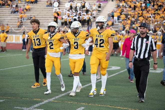 Pueblo East's captains take the field at Dutch Clark Stadium for the coin toss at the start of the 2023 Cannon Game against Pueblo South.
