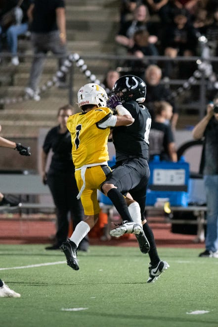 Pueblo South's Damian Cordova, right, comes down with an interception with pressure coming from Pueblo East's Pocky Amaro during the 2023 Cannon Game at Dutch Clark Stadium on Friday, September 22, 2023.