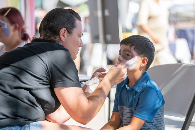 Andrew Santiago, 7, gets his face painted by Melissa Knowlton at the 28th Annual Chile and Frijoles Festival on Saturday, Sept. 24, 2022.