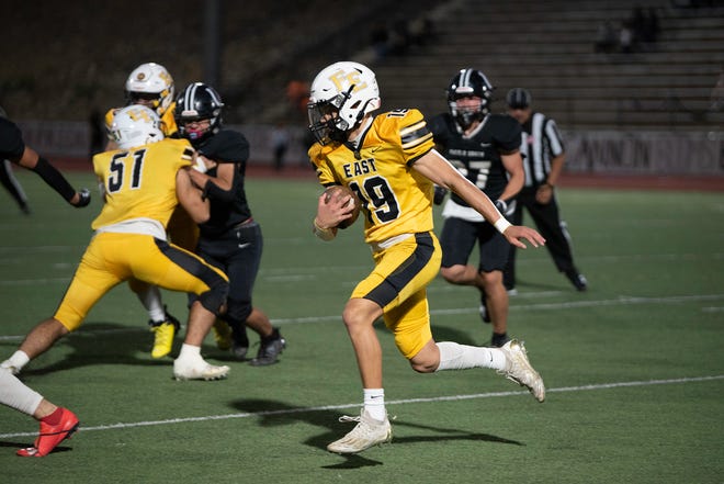 Pueblo East's Dolphka Lewis gains yards on a keeper play during the 2023 Cannon Game against Pueblo South at Dutch Clark Stadium.